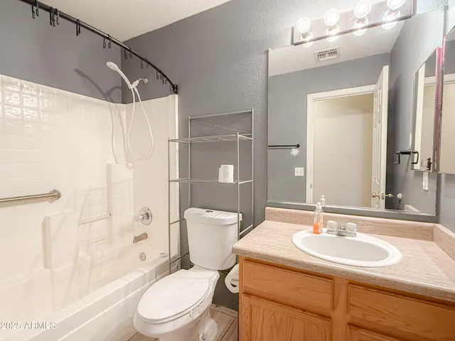 a bathroom with a sink toilet mirror and shower