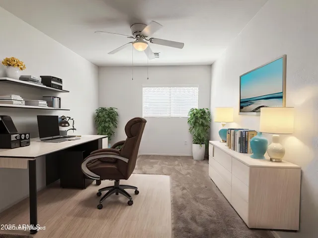 a livingroom with workspace and a couch