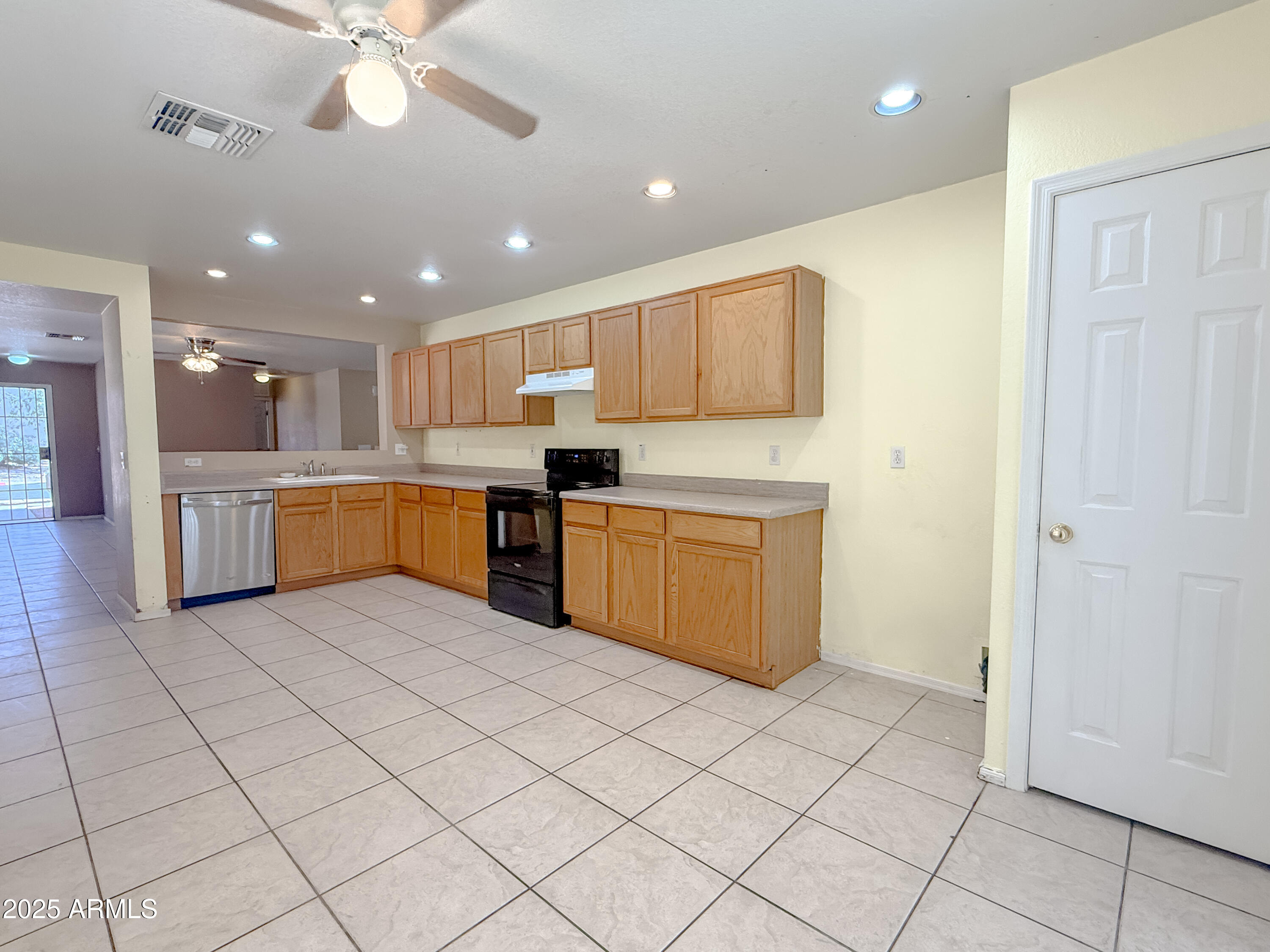 1042 South Clancy Circle Mesa, AZ 85208 - Photo 4 of 14 a kitchen with stainless steel appliances granite countertop a stove top oven a sink dishwasher and a refrigerator with wooden floor