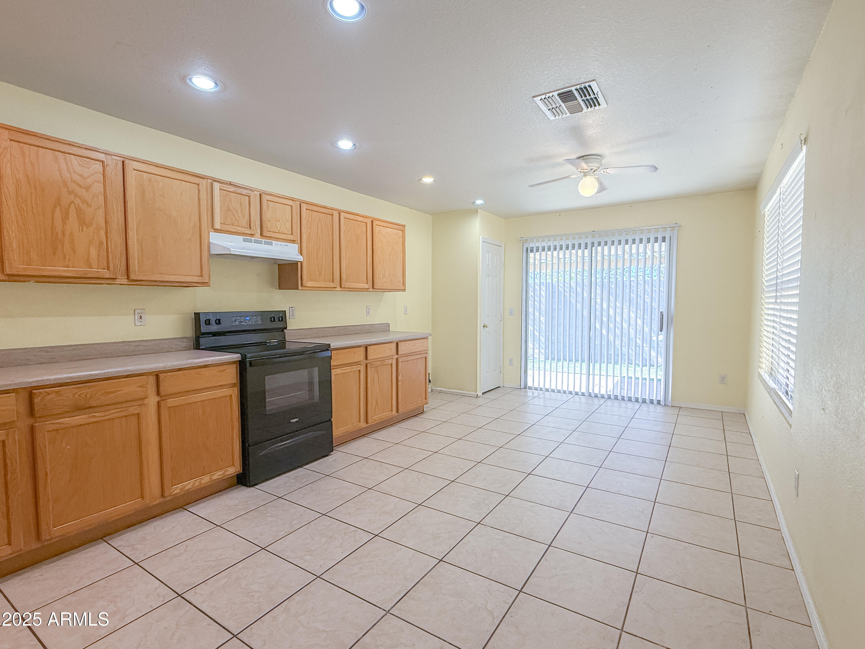 1042 South Clancy Circle Mesa, AZ 85208 - Photo 5 of 14 a kitchen with a sink window and cabinets