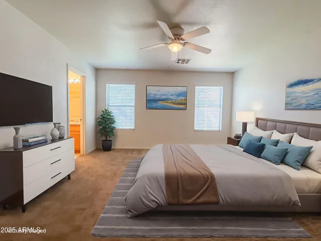 a bedroom with a large bed and flat tv screen on dresser
