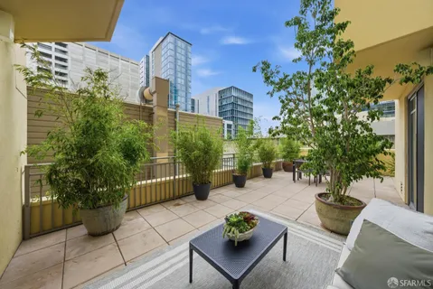 a view of a patio with table and chairs and potted plants