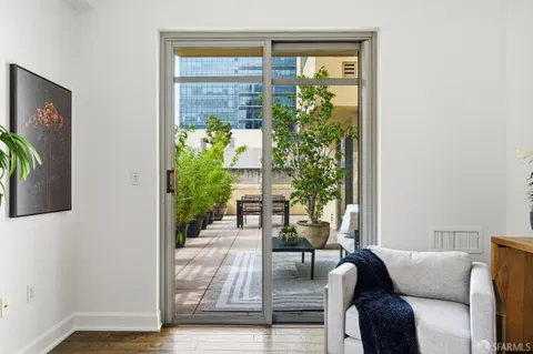 a view of a patio with table and chairs and potted plants