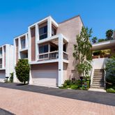 a front view of a house with a yard and a garage