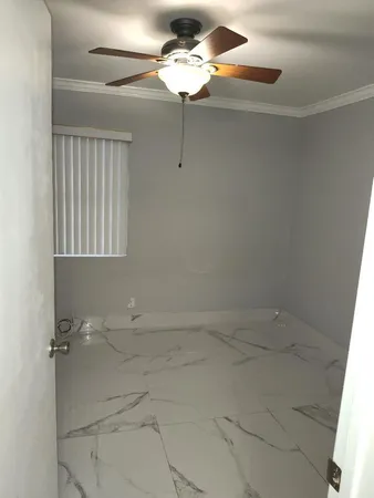 a bathroom with a light fixture a sink and a window