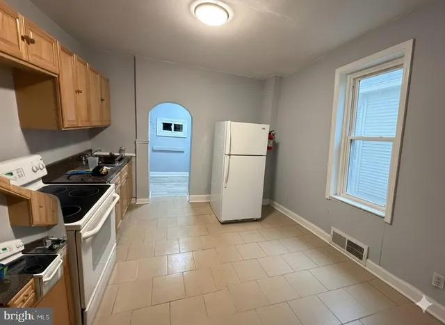 a kitchen with a refrigerator a stove a microwave and cabinets