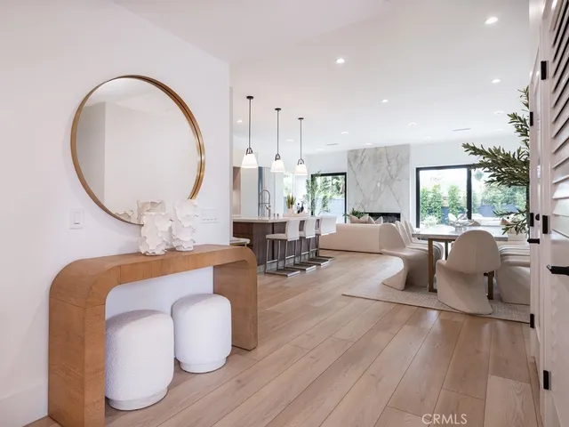 a living room with furniture and a large mirror