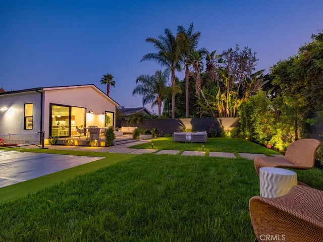 a view of yard with swimming pool and green space
