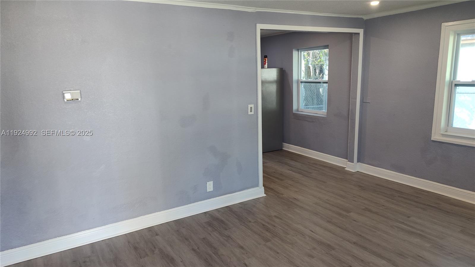 849 West 2nd Street, Unit A Riviera Beach, FL 33404 - Photo 3 of 7 an empty room with wooden floor and windows