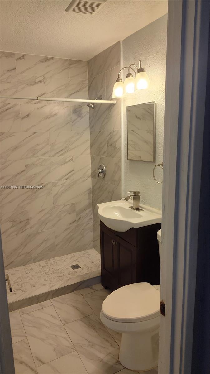 849 West 2nd Street, Unit A Riviera Beach, FL 33404 - Photo 4 of 7 a bathroom with a sink and a mirror