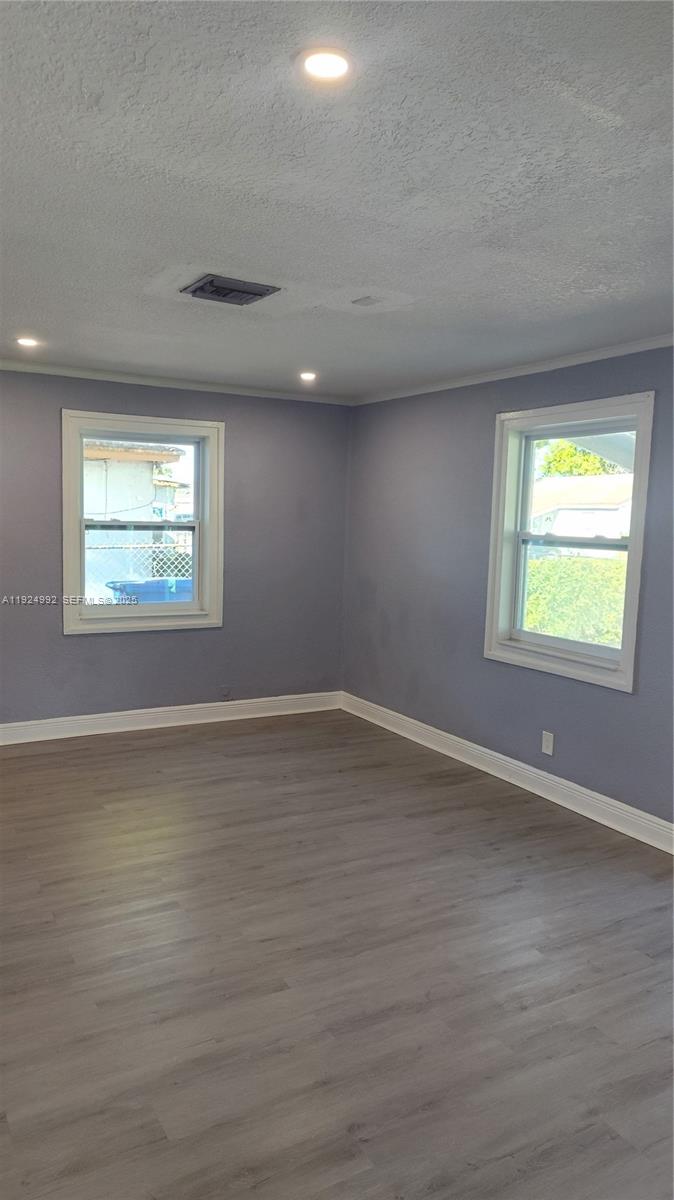 849 West 2nd Street, Unit A Riviera Beach, FL 33404 - Photo 5 of 7 an empty room with wooden floor and windows