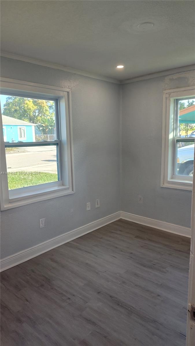 849 West 2nd Street, Unit A Riviera Beach, FL 33404 - Photo 6 of 7 a view of an empty room with wooden floor and a window