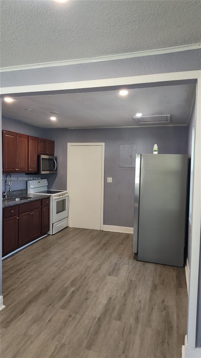 849 West 2nd Street, Unit A Riviera Beach, FL 33404 - Photo 7 of 7 a view of a kitchen with a sink and cabinets