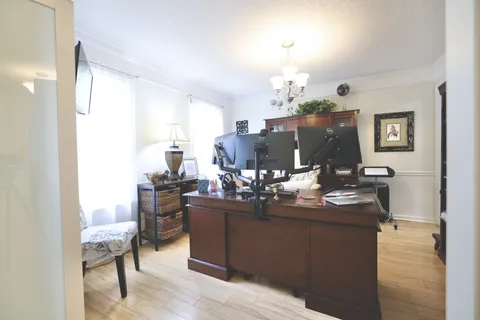 a dining room with kitchen island granite countertop furniture and a chandelier