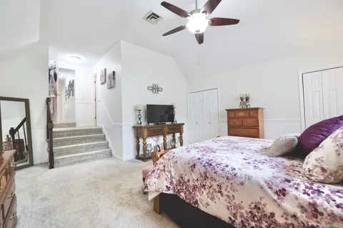 a bedroom with a bed and a chandelier