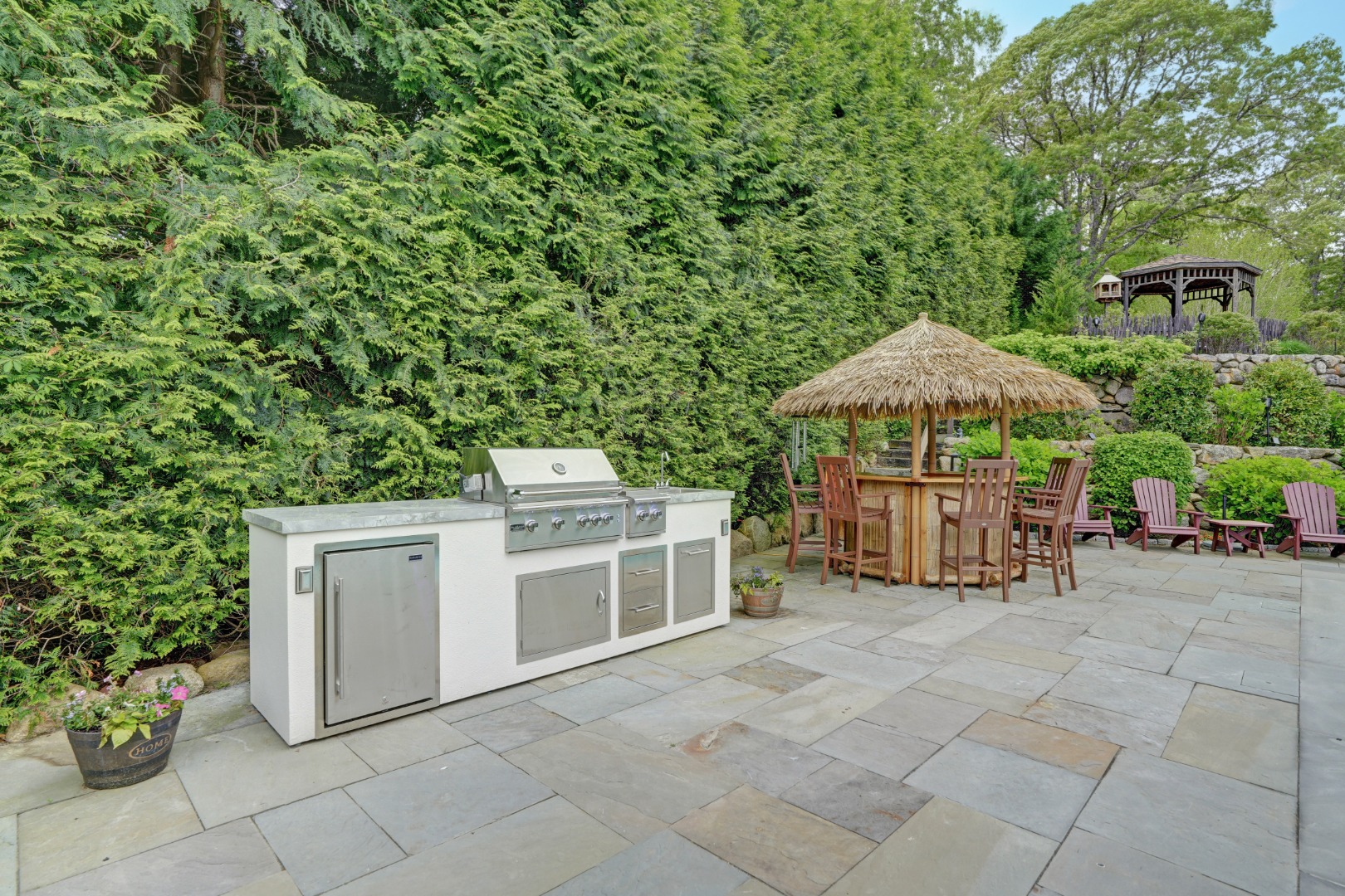 8 Fresh Pond Road Oak Bluffs, MA 02557 - Photo 29 of 36 a view of a patio with a table and chairs under an umbrella
