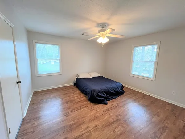 a view of a room with wooden floor and window