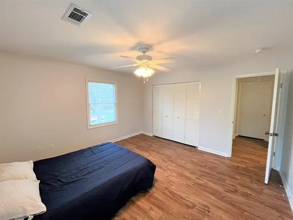 a bedroom with a bed and a ceiling fan