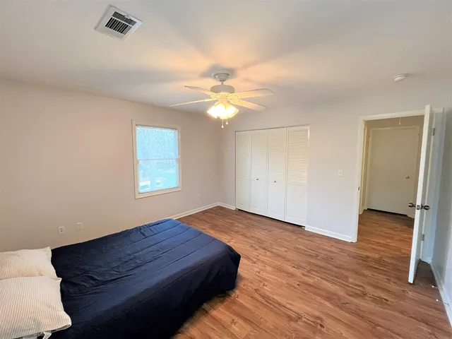 a bedroom with a bed and a ceiling fan