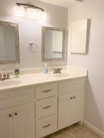 a bathroom with a sink vanity and mirror