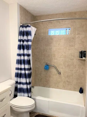 a bathroom with a toilet and a shower