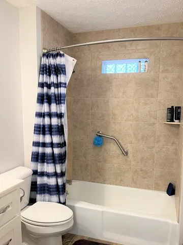 a bathroom with a toilet and a shower