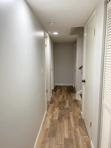 a view of a hallway with wooden floor