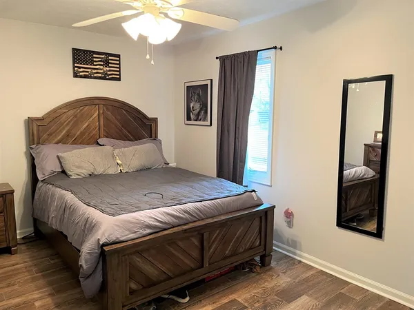 a bedroom with a bed and a mirror