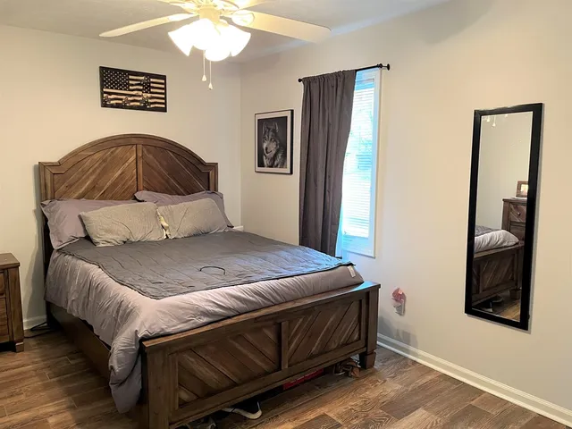 a bedroom with a bed and a mirror