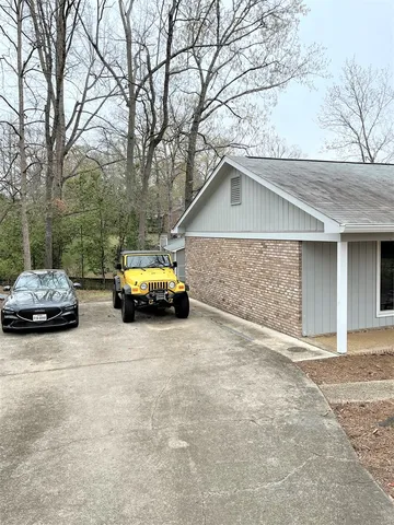 a car parked in front of white house