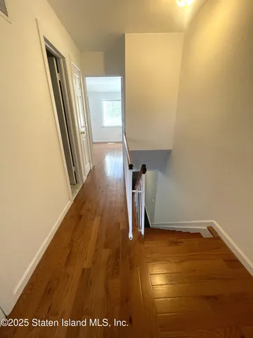 a view of a room with wooden floor
