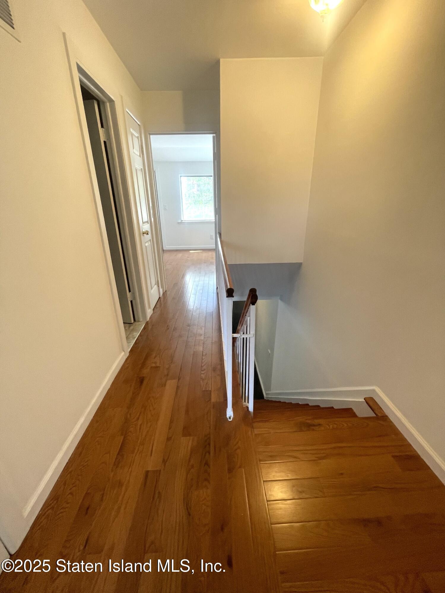 421 Hylan Boulevard Staten Island, NY 10305 - Photo 8 of 10 a view of a room with wooden floor