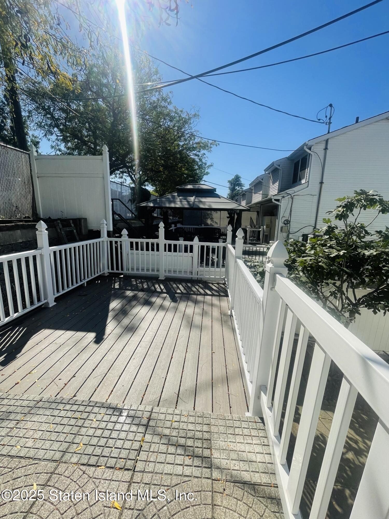 421 Hylan Boulevard Staten Island, NY 10305 - Photo 9 of 10 a view of balcony with wooden floor and seating space