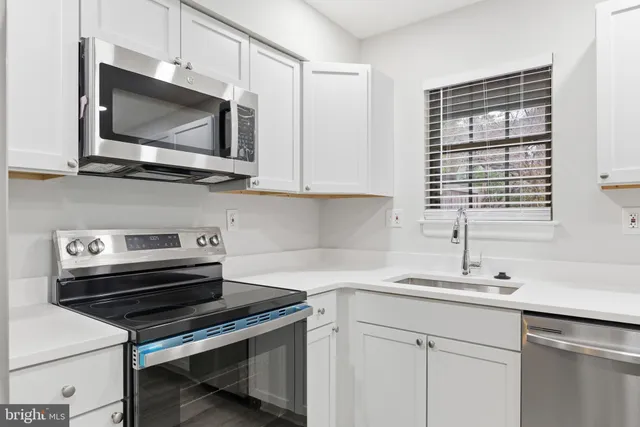 a kitchen with a stove microwave and sink