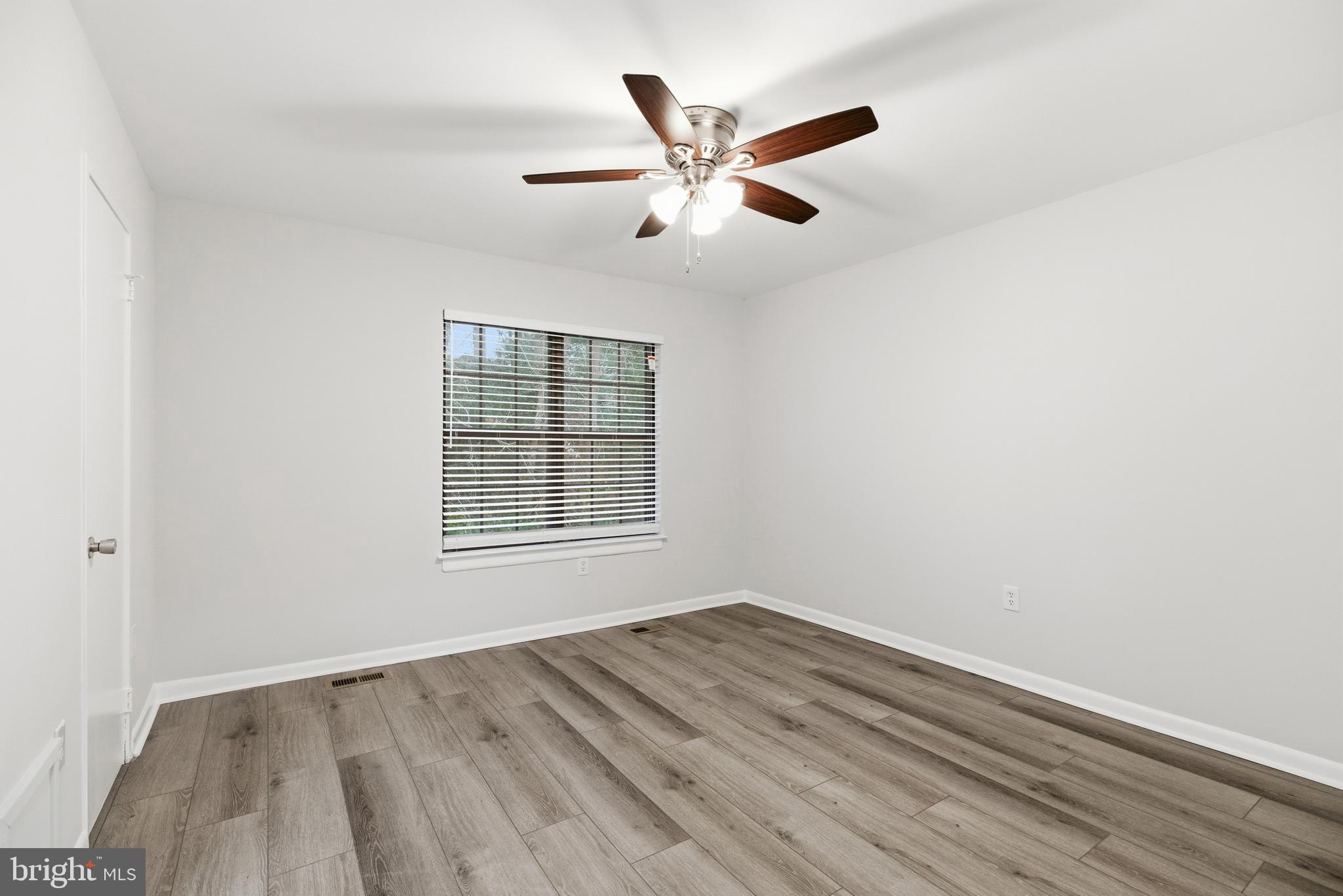 2006 Headlands Circle Reston, VA 20191 - Photo 18 of 29 an empty room with wooden floor fan and windows