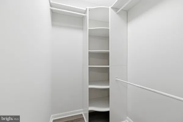 a view of walk in closet with empty racks