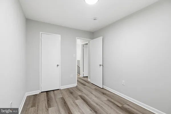 a view of an empty room and wooden floor