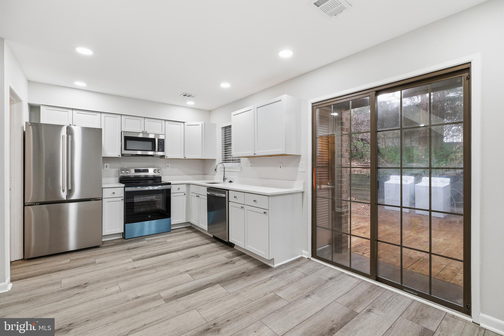 2006 Headlands Circle Reston, VA 20191 - Photo 9 of 29 a kitchen with a refrigerator a sink and a stove top oven