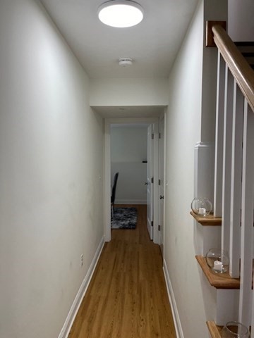 35 Fredonian Street, Unit K Shirley, MA 01464 - Photo 12 of 18 a view of a hallway with wooden floor and a bathroom