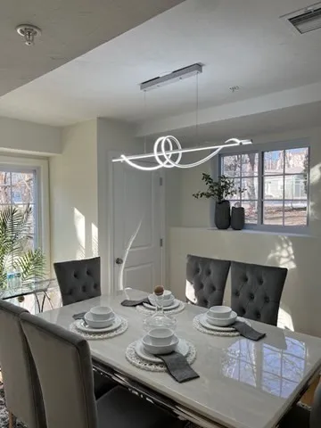 a dinning room with furniture and chandelier