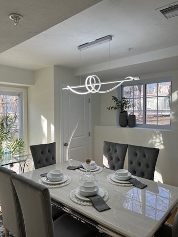 35 Fredonian Street, Unit K Shirley, MA 01464 - Photo 13 of 18 a dinning room with furniture and chandelier
