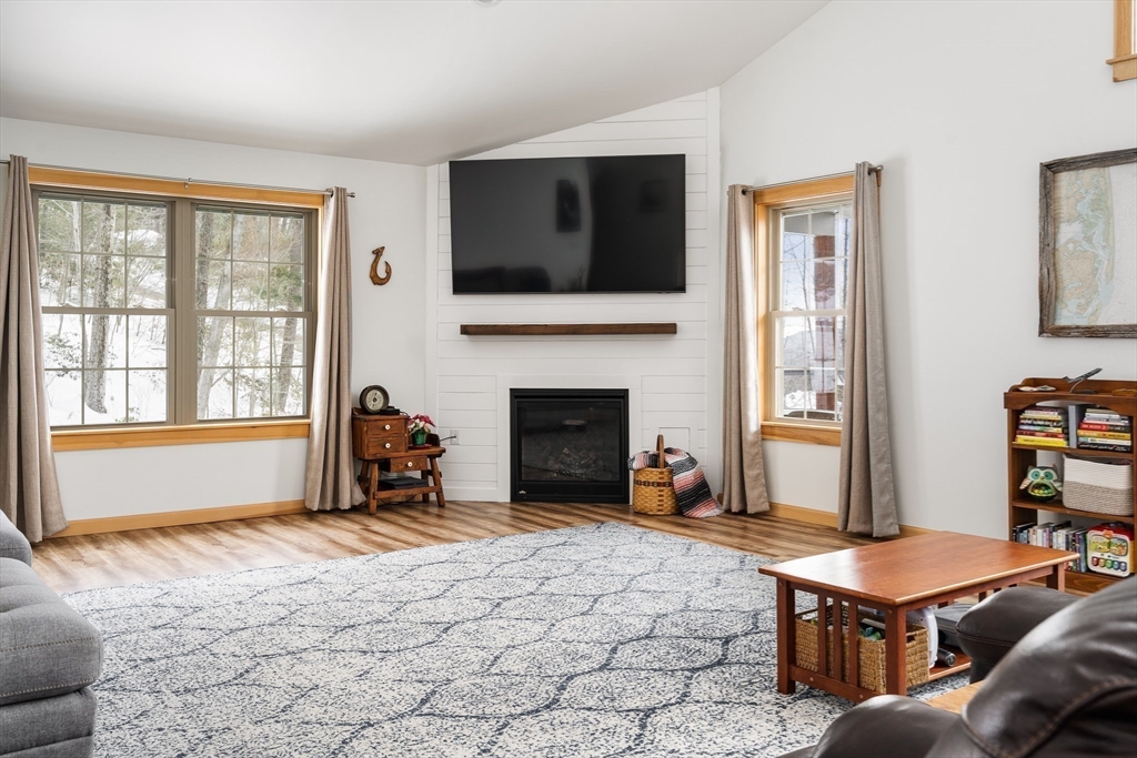 79 Burt Road Westhampton, MA 01027 - Photo 12 of 42 a living room with furniture a flat screen tv and a fireplace