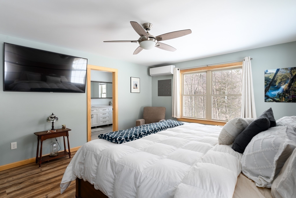 79 Burt Road Westhampton, MA 01027 - Photo 25 of 42 a bedroom with a bed window and a flat screen tv