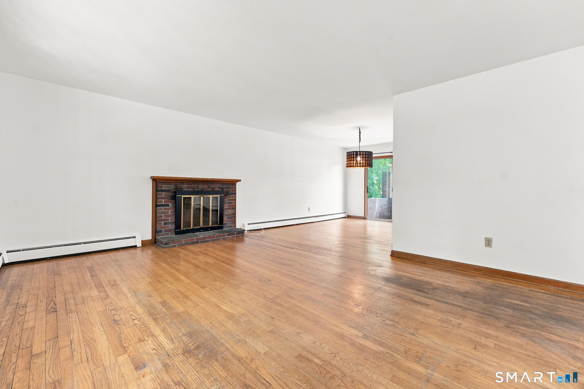 448 Mixville Road Cheshire, CT 06410 - Photo 7 of 32 a view of an empty room with wooden floor and a window