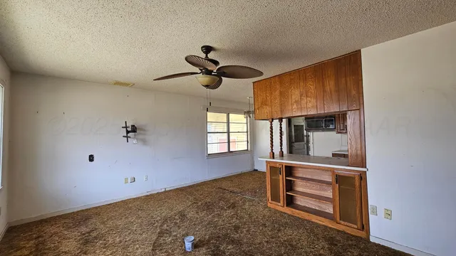 a view of room with window and ceiling fan