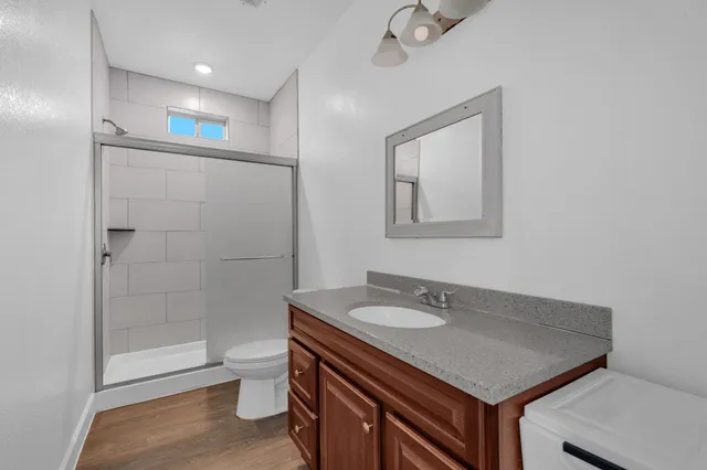 a bathroom with a sink toilet and shower