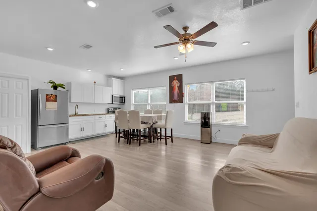 a living room with furniture and kitchen view
