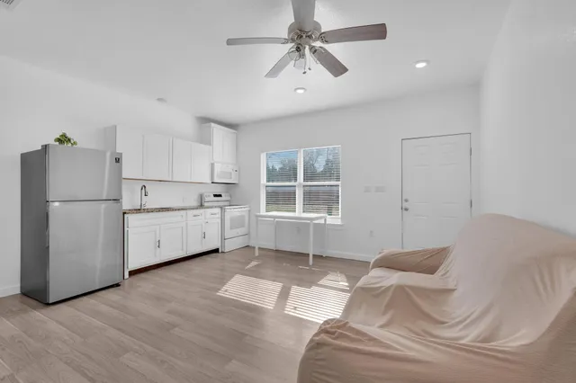 a kitchen with a white cabinets and refrigerator