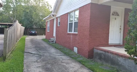 a pathway of a house with brick walls