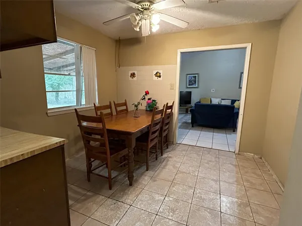 a living room with a table and chairs